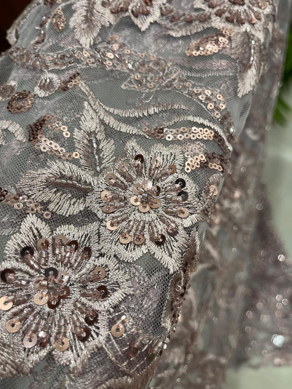 Net fabric with heavy embroidery